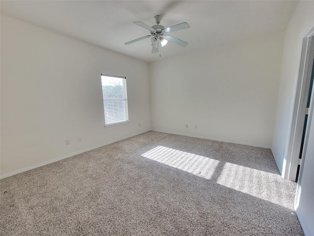 empty room featuring ceiling fan and light colored carpet