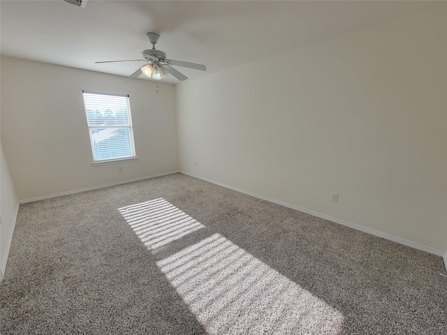 carpeted spare room with ceiling fan