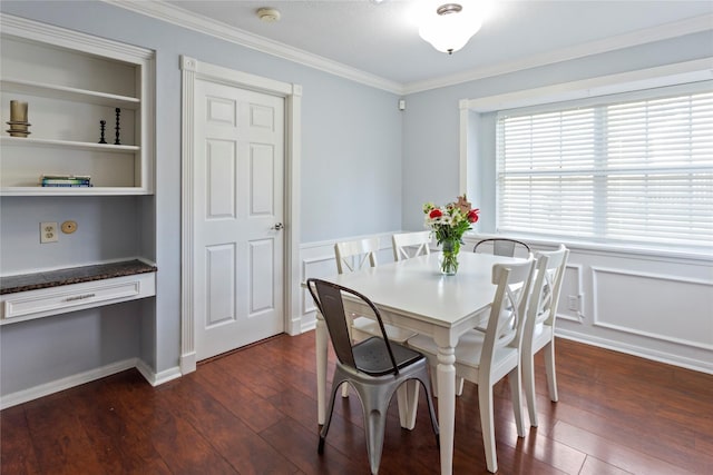 dining room with dark hardwood / wood-style flooring, built in shelves, and ornamental molding