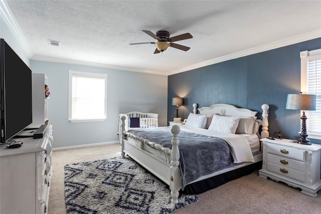 bedroom featuring ceiling fan, ornamental molding, light colored carpet, and multiple windows