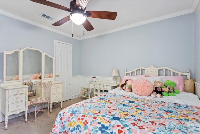 carpeted bedroom featuring ornamental molding and ceiling fan