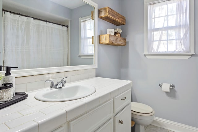 bathroom with tile patterned floors, vanity, and toilet