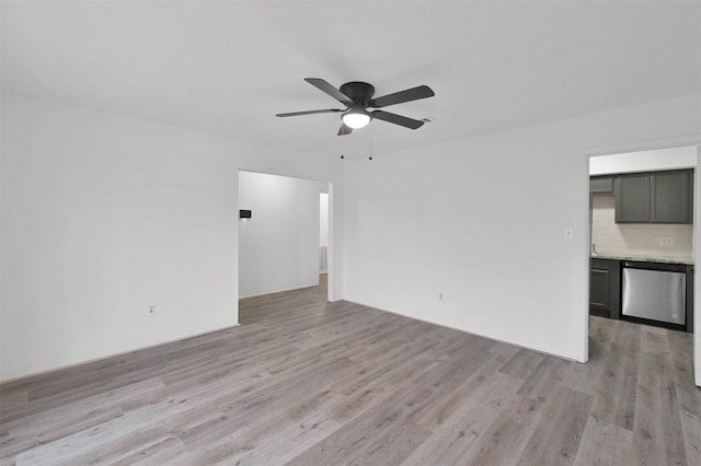 unfurnished living room featuring ceiling fan and light wood-type flooring