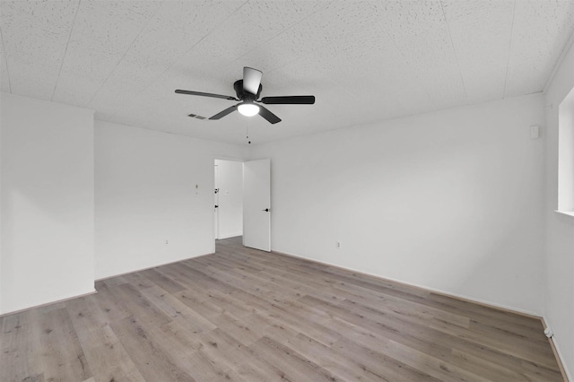 empty room featuring light hardwood / wood-style floors and ceiling fan