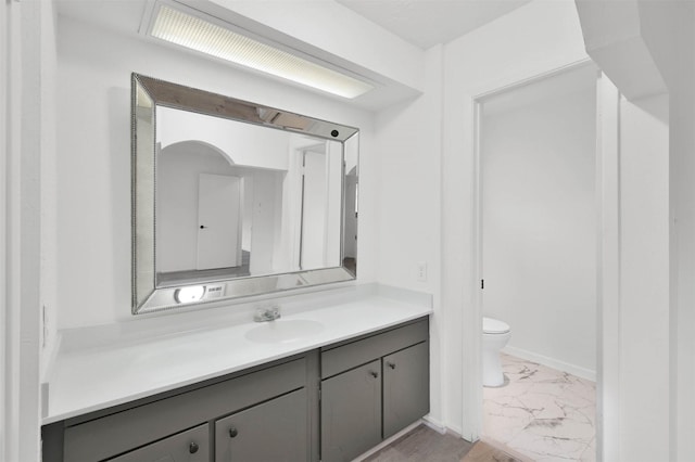 bathroom featuring vanity and toilet