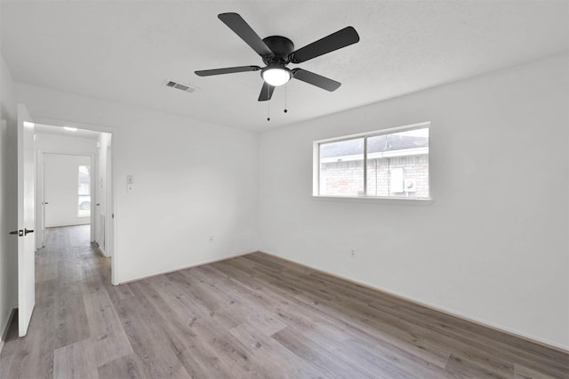 empty room featuring light wood-type flooring and ceiling fan