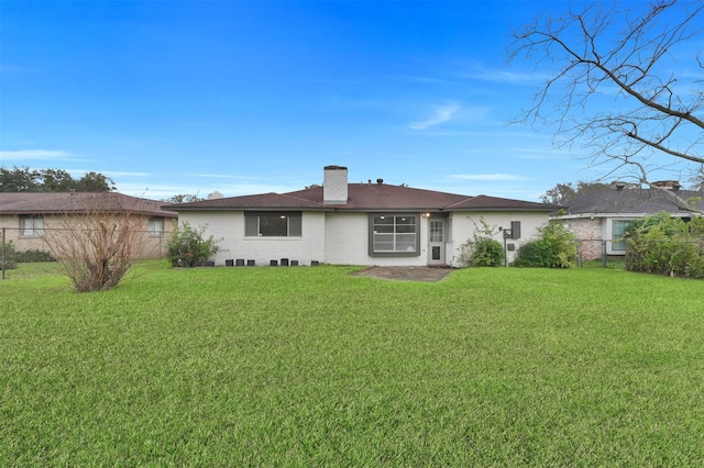 back of house with a lawn