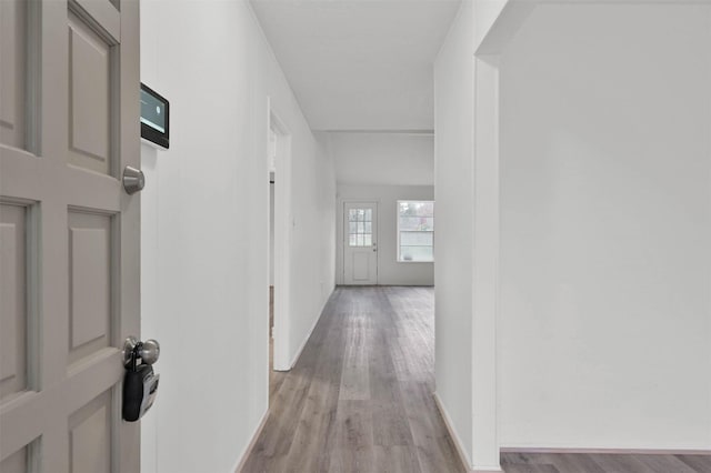 corridor with light wood-type flooring