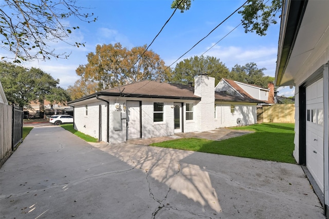 back of property featuring a patio area and a yard