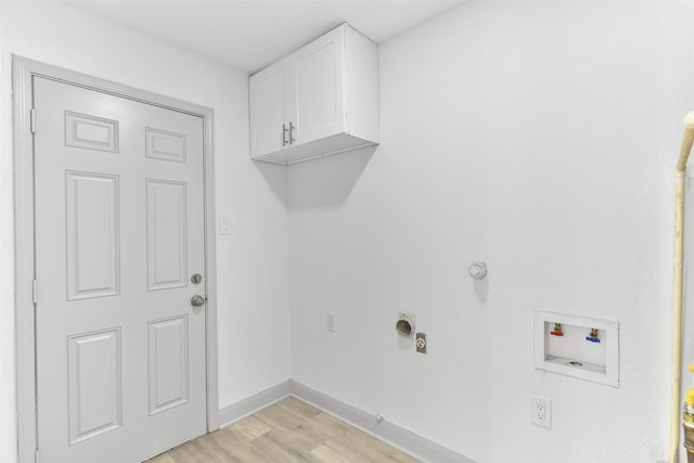 laundry room featuring cabinets, hookup for a washing machine, light wood-type flooring, hookup for an electric dryer, and hookup for a gas dryer