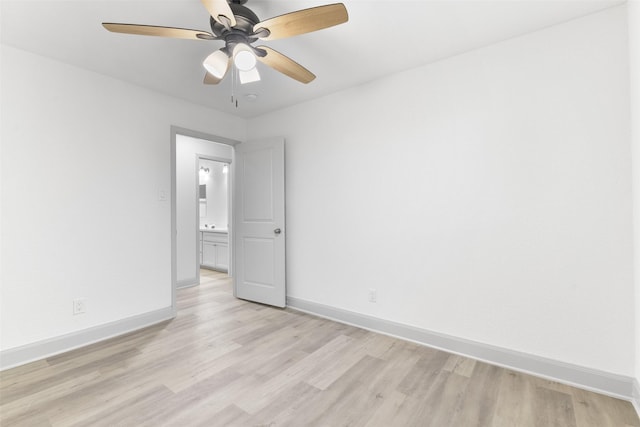 empty room with ceiling fan and light hardwood / wood-style flooring