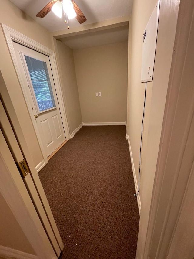 hallway with dark colored carpet