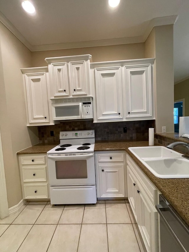 kitchen with white cabinets, white appliances, sink, and light tile patterned floors