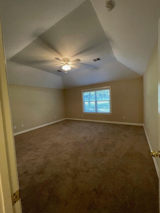 carpeted empty room with ceiling fan and lofted ceiling