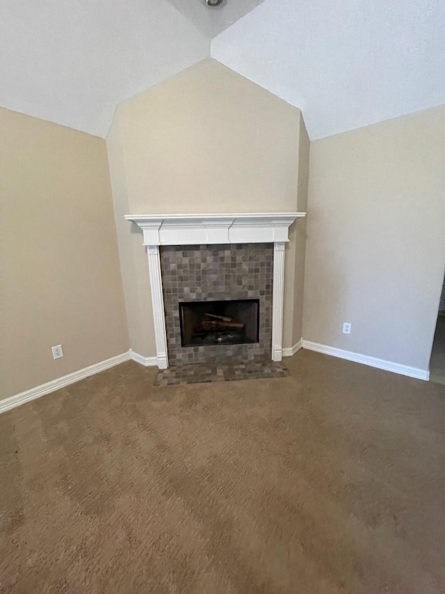 unfurnished living room with carpet, lofted ceiling, and a tile fireplace