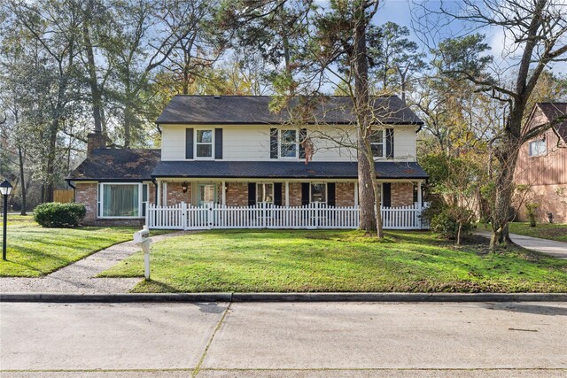 view of front property with a front lawn and covered porch