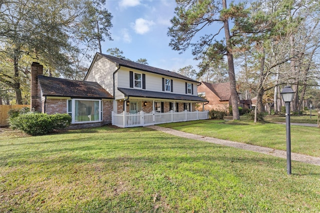 view of front of property with covered porch and a front lawn