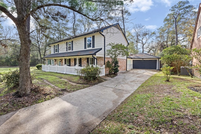 view of front of home featuring a porch, a front lawn, central AC unit, a garage, and an outdoor structure