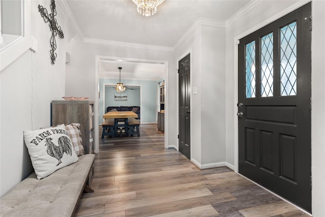 foyer entrance featuring hardwood / wood-style floors and ornamental molding