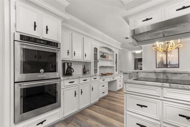 kitchen with white cabinetry, double oven, and crown molding