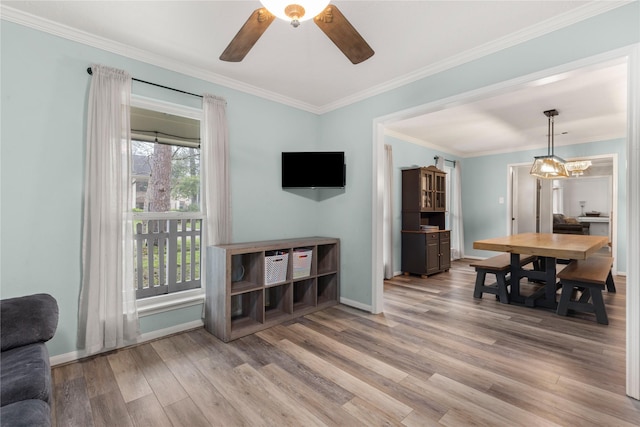 dining area with crown molding, a healthy amount of sunlight, and light hardwood / wood-style floors