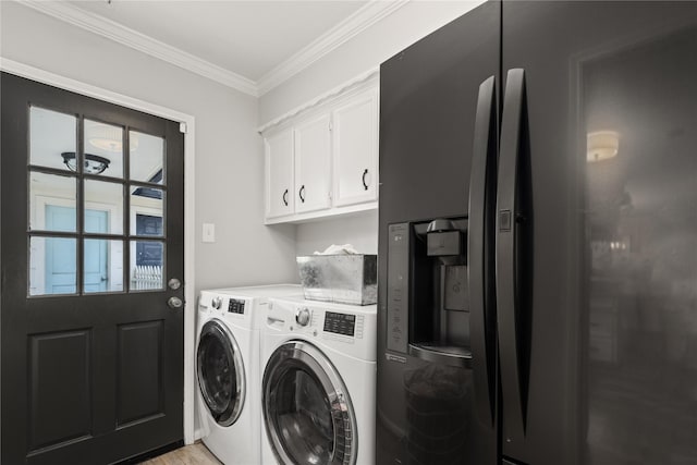 washroom featuring washer and clothes dryer, cabinets, crown molding, and light hardwood / wood-style flooring