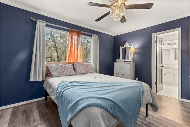 bedroom with hardwood / wood-style flooring, ensuite bath, ceiling fan, and crown molding