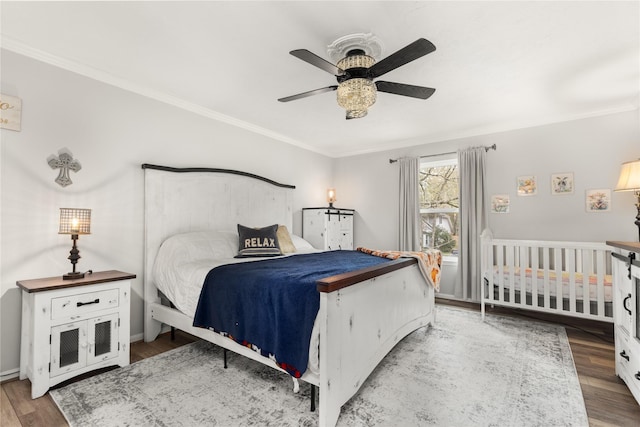 bedroom with hardwood / wood-style flooring, ceiling fan, and crown molding