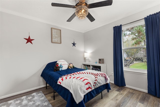 bedroom featuring ceiling fan, crown molding, and hardwood / wood-style flooring