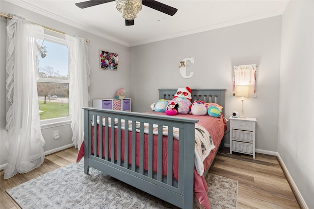 bedroom featuring ceiling fan, wood-type flooring, and ornamental molding