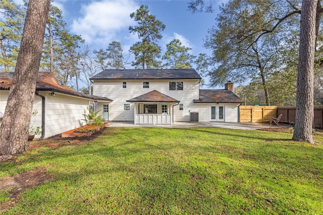 back of property featuring a patio area, central air condition unit, a yard, and french doors