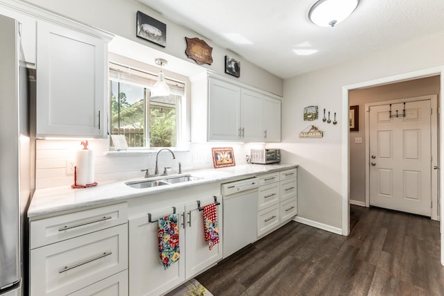 kitchen featuring decorative backsplash, white dishwasher, sink, white cabinets, and dark hardwood / wood-style floors