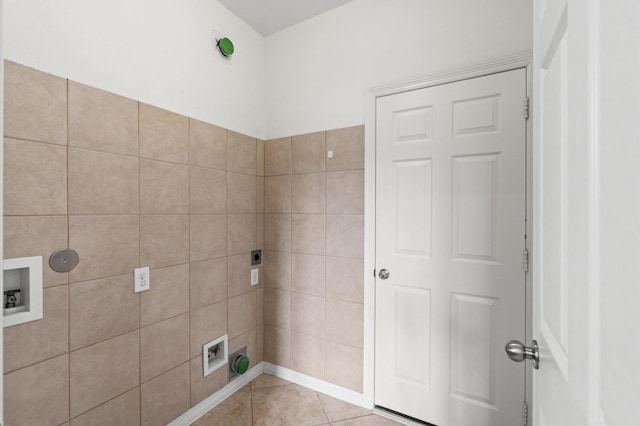 laundry area with electric dryer hookup, light tile patterned flooring, and washer hookup