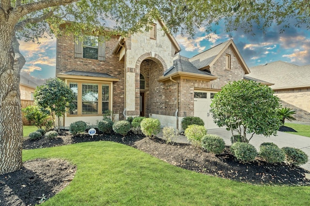 view of front facade with a front lawn and a garage