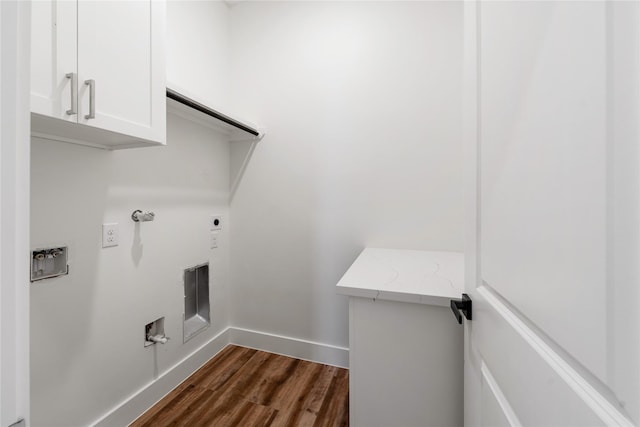 laundry room featuring electric dryer hookup, dark hardwood / wood-style flooring, cabinets, and hookup for a gas dryer