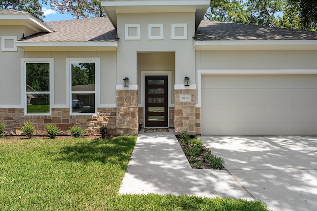 entrance to property featuring a yard and a garage