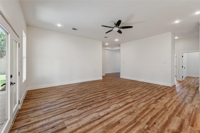 spare room with light wood-type flooring and ceiling fan