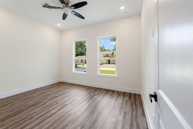 spare room featuring hardwood / wood-style floors and ceiling fan