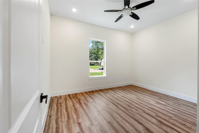 empty room featuring ceiling fan and light hardwood / wood-style flooring