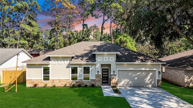 view of front of house with a yard and a garage