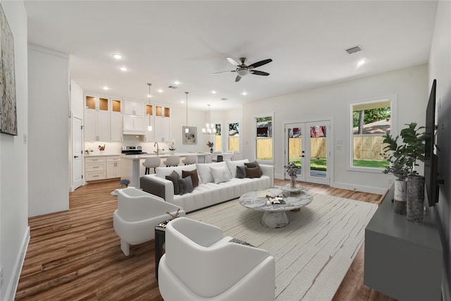 living room featuring french doors, dark hardwood / wood-style floors, ceiling fan, and sink