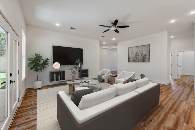 living room featuring ceiling fan and hardwood / wood-style floors