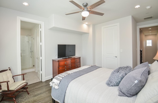 bedroom featuring ensuite bathroom, ceiling fan, and dark wood-type flooring