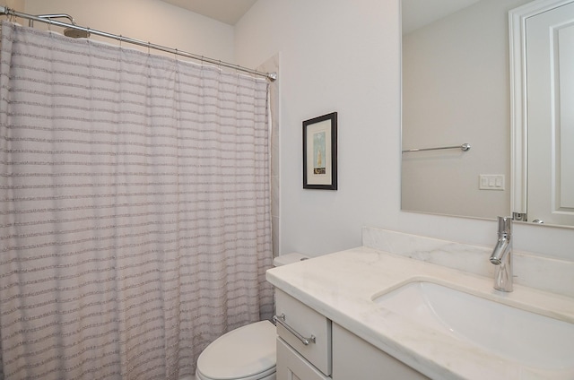 bathroom with vanity, toilet, and walk in shower