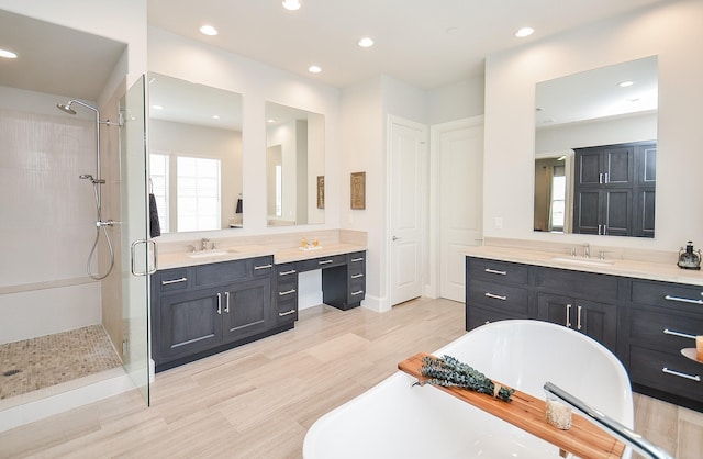 bathroom featuring plus walk in shower and vanity