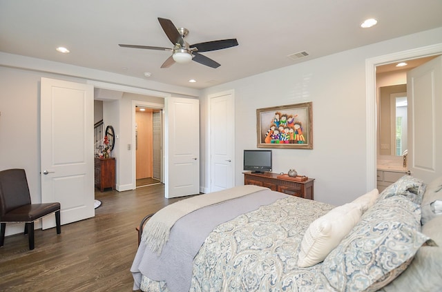 bedroom with dark hardwood / wood-style flooring, ensuite bathroom, and ceiling fan