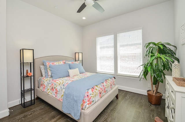 bedroom with dark hardwood / wood-style flooring and ceiling fan