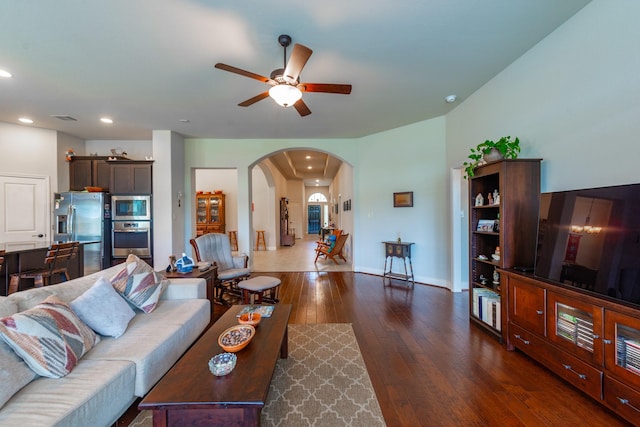 living room featuring ceiling fan and dark wood-type flooring