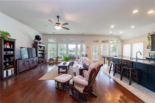 living room with vaulted ceiling, ceiling fan, dark wood-type flooring, and sink