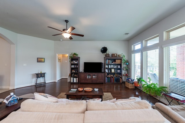 living room featuring ceiling fan and dark hardwood / wood-style flooring